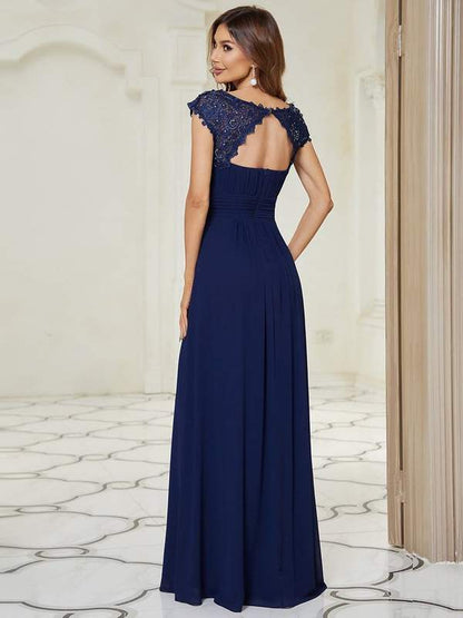 Back shot of woman in elegant sleeve lace and chiffon bridesmaid dress in navy